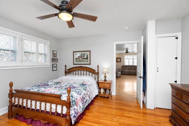 bedroom with ceiling fan and light wood-type flooring