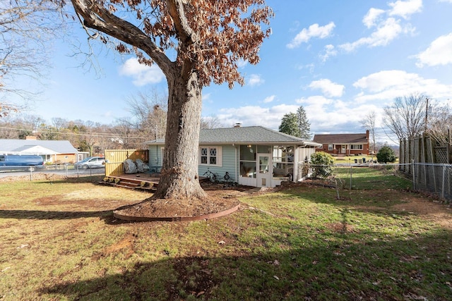 back of property featuring a sunroom and a yard