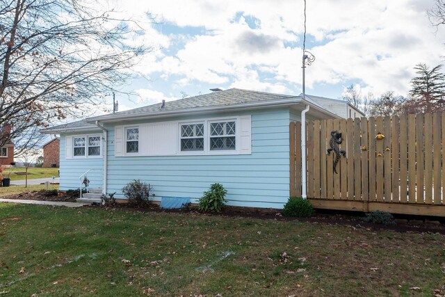 view of side of home with a lawn