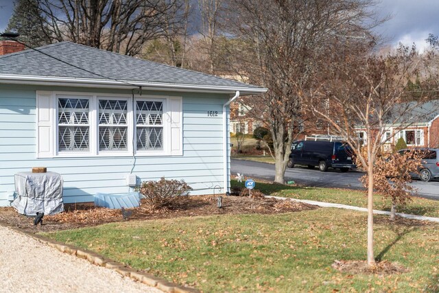 view of side of home featuring a yard