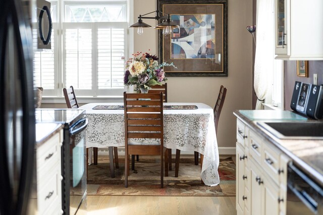 dining space featuring light wood-type flooring