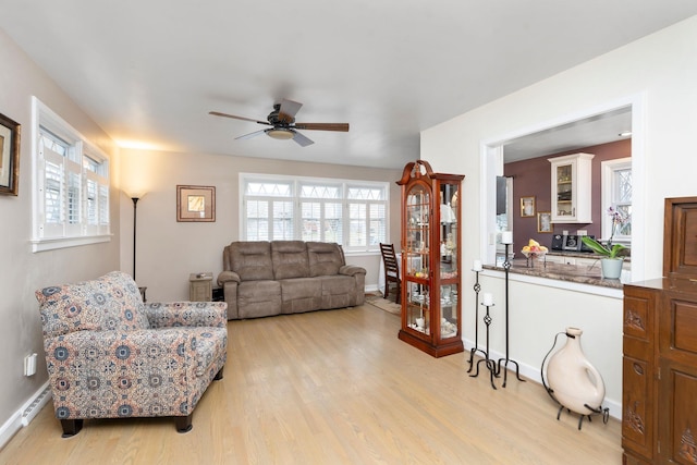 living room featuring ceiling fan and light wood-type flooring