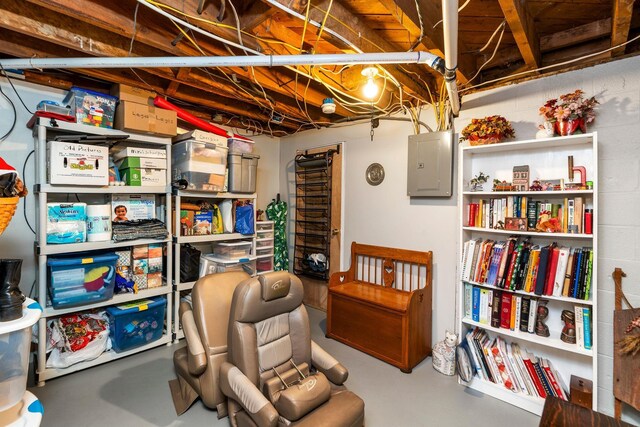 sitting room featuring concrete flooring and electric panel