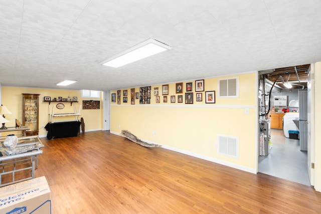 basement with wood-type flooring