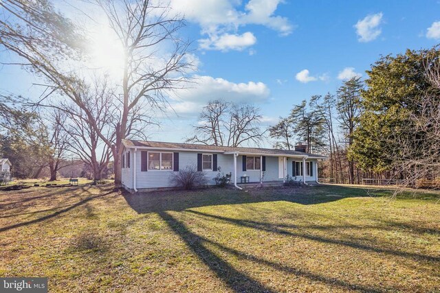 single story home with a porch and a front yard