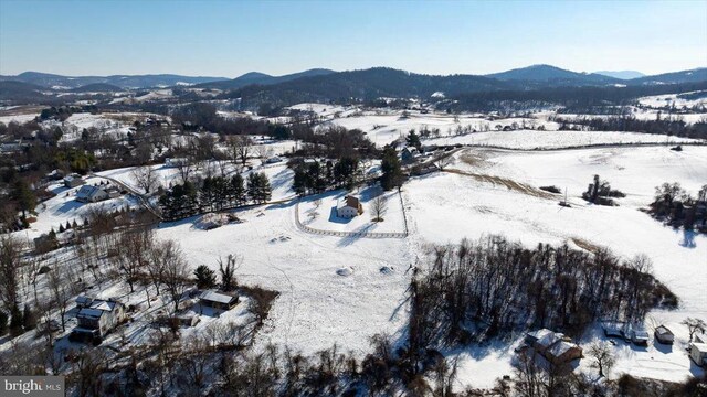 snowy aerial view with a mountain view