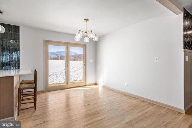 dining room featuring an inviting chandelier and light hardwood / wood-style floors