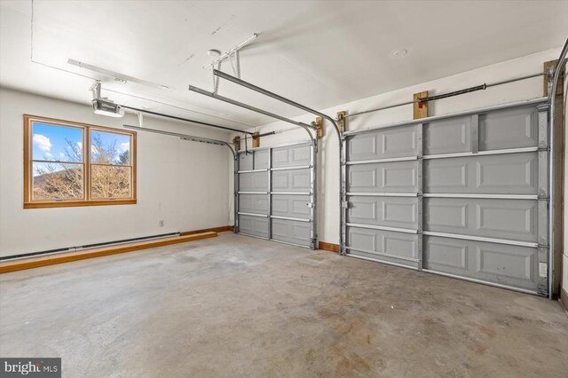 garage with a garage door opener and a baseboard heating unit