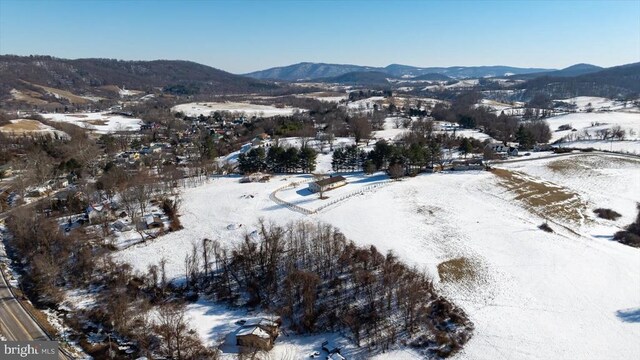 snowy aerial view featuring a mountain view