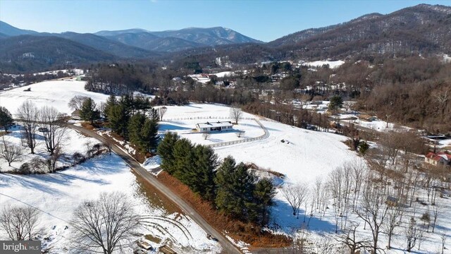 snowy aerial view with a mountain view