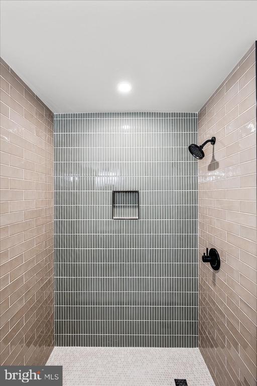 bathroom with a tile shower