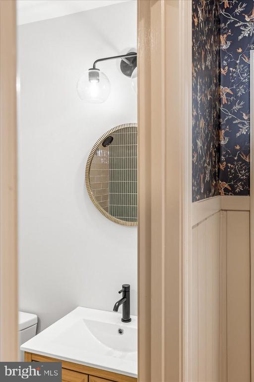 bathroom with vanity, a shower, and toilet