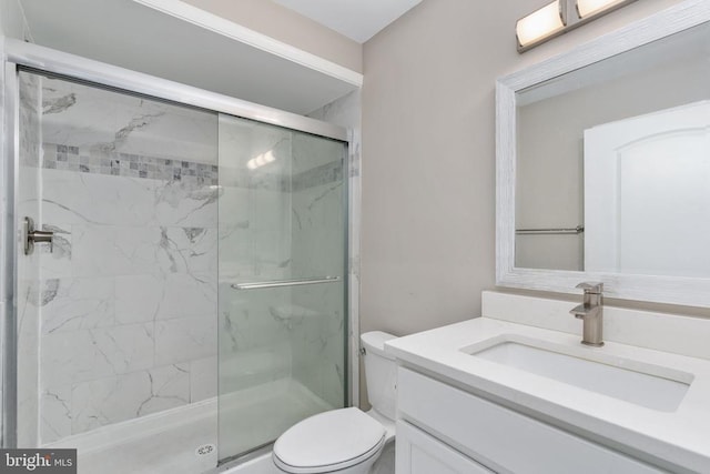 bathroom featuring walk in shower, vanity, and toilet