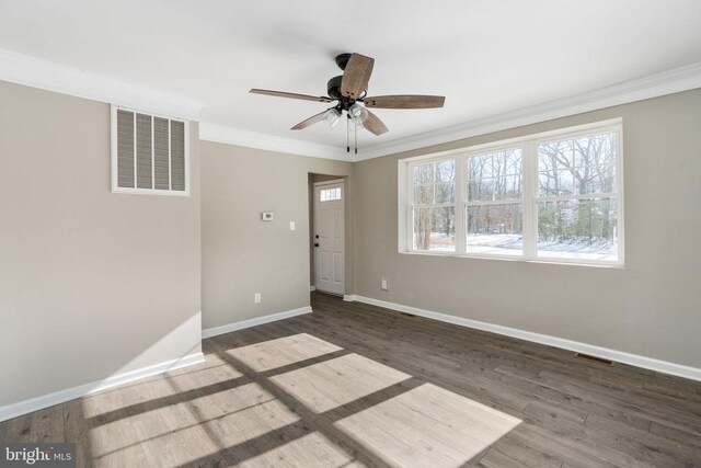 unfurnished room with crown molding, ceiling fan, and dark hardwood / wood-style flooring