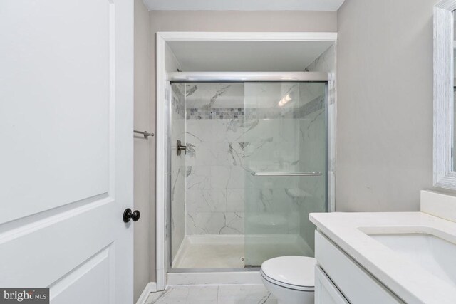 bathroom featuring walk in shower, vanity, and toilet