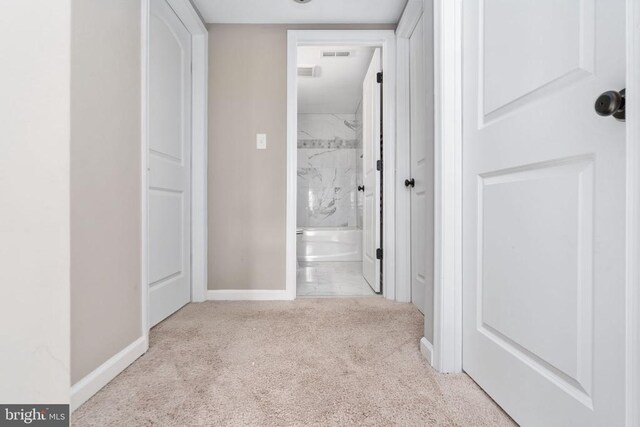 hallway featuring light carpet