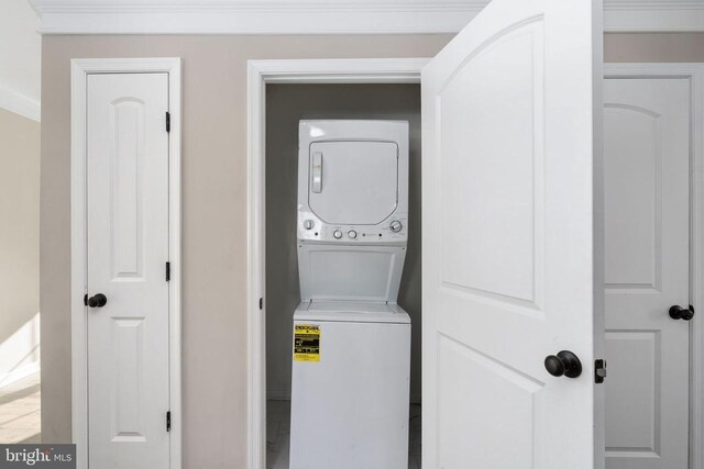 clothes washing area with stacked washer / drying machine