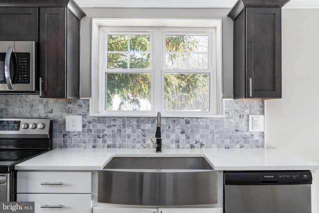 kitchen with dark brown cabinetry, appliances with stainless steel finishes, sink, and plenty of natural light