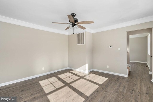 empty room featuring ornamental molding, dark hardwood / wood-style floors, and ceiling fan