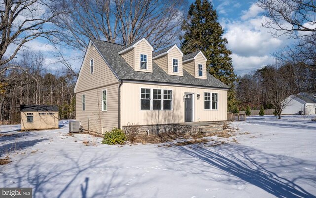 view of front of home featuring central AC unit and a storage unit