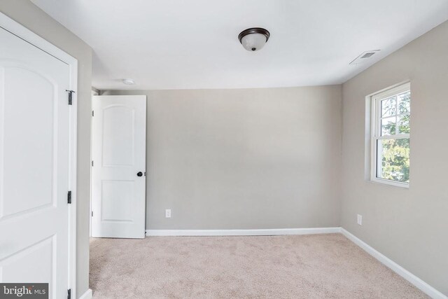 empty room featuring light colored carpet