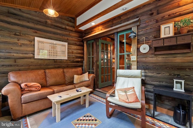 living area featuring carpet, rustic walls, and wooden ceiling
