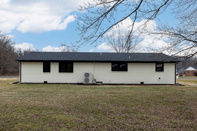 rear view of house featuring a yard and ac unit