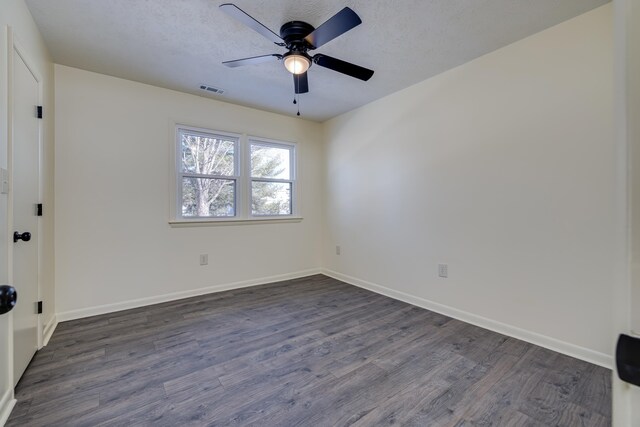 unfurnished room with ceiling fan, dark hardwood / wood-style flooring, and a textured ceiling