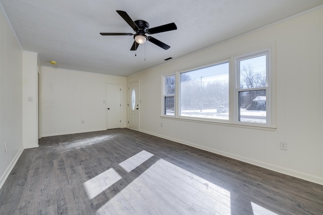 empty room with dark hardwood / wood-style flooring, ceiling fan, and a textured ceiling