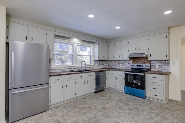 kitchen featuring white cabinetry, sink, backsplash, and appliances with stainless steel finishes