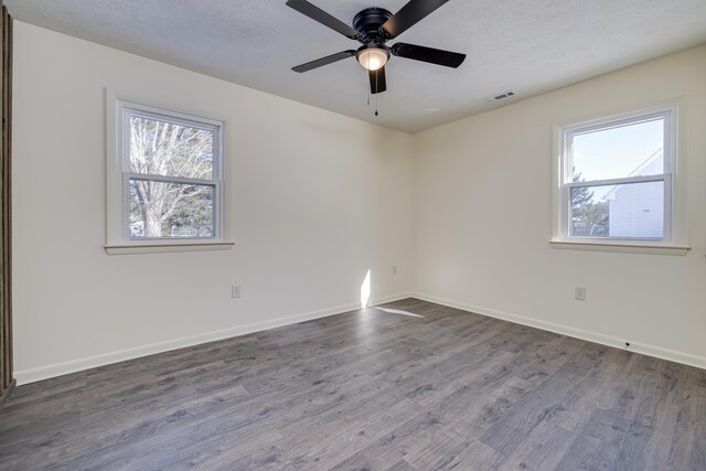 spare room with ceiling fan, wood-type flooring, and a textured ceiling