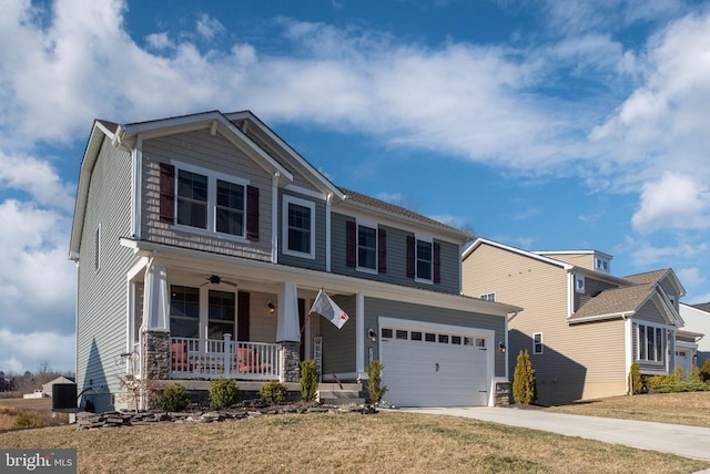 craftsman house with a front lawn, a ceiling fan, driveway, covered porch, and a garage