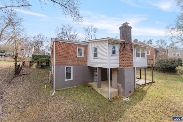 back of house with a patio and a yard