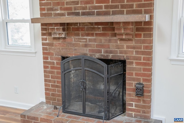 room details with a brick fireplace and hardwood / wood-style floors