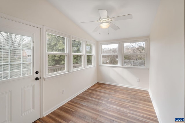 unfurnished sunroom featuring a wealth of natural light, vaulted ceiling, and ceiling fan