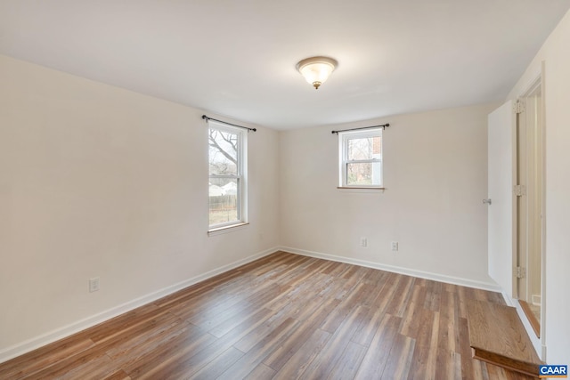 spare room with hardwood / wood-style floors