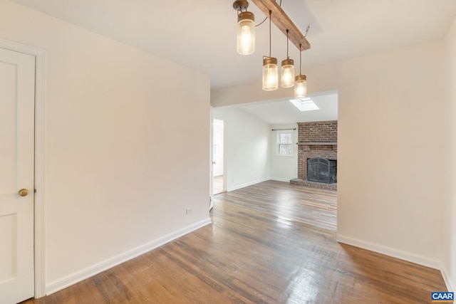 unfurnished living room featuring lofted ceiling, a fireplace, and dark hardwood / wood-style floors