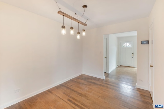 unfurnished dining area featuring wood-type flooring