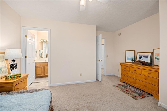 bedroom with ceiling fan, connected bathroom, and light carpet