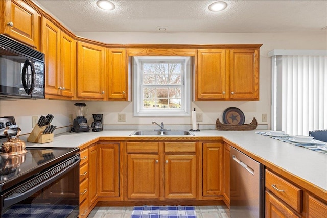 kitchen with sink, a textured ceiling, and black appliances