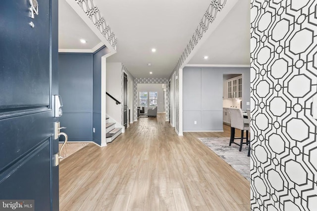 foyer featuring baseboards, recessed lighting, crown molding, stairs, and wood finished floors