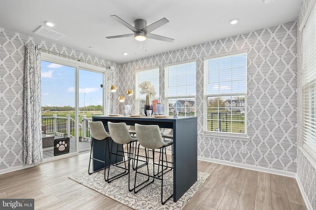 dining area featuring light wood-style floors, a ceiling fan, visible vents, and recessed lighting