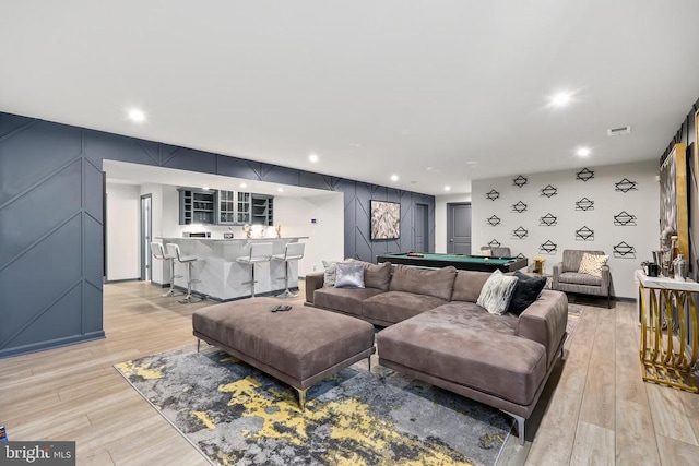living room featuring light wood-type flooring, bar area, pool table, and visible vents
