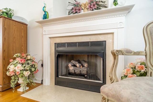 interior details with a fireplace and wood finished floors