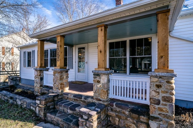 entrance to property featuring covered porch