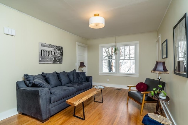 living room with ornamental molding and hardwood / wood-style floors