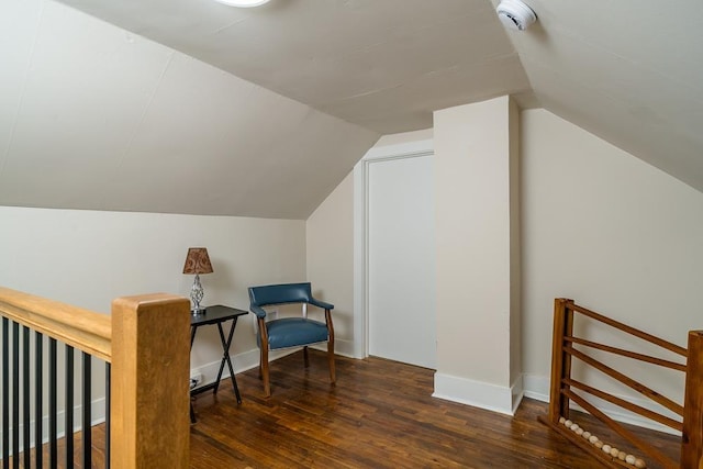 sitting room featuring vaulted ceiling and dark hardwood / wood-style floors