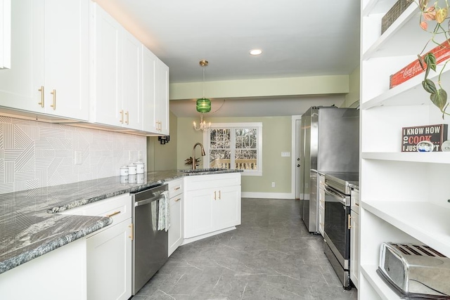 kitchen featuring sink, white cabinetry, decorative light fixtures, appliances with stainless steel finishes, and decorative backsplash