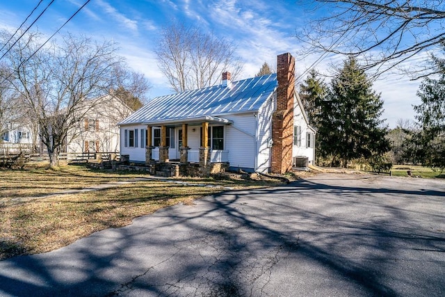 view of front of property with cooling unit and covered porch