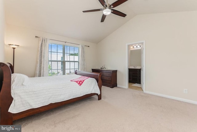 carpeted bedroom with ceiling fan, lofted ceiling, and ensuite bathroom